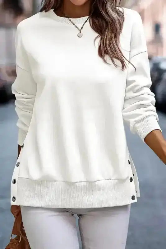 Front view of White Snap Button Pullover with side button detailing and ribbed hem, perfect for chic winter layering.
