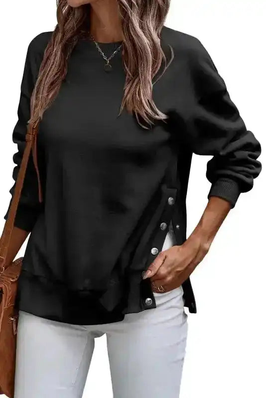 Black Snap Button Pullover styled with white jeans, showing side split button detail and casual winter fashion appeal.