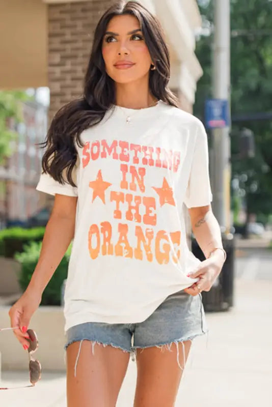 Something in the orange graphic t-shirt