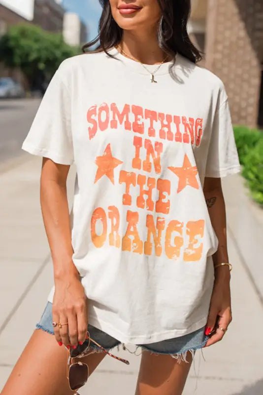 Something in the orange graphic t-shirt