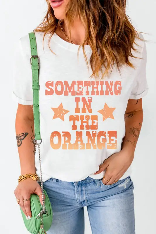 Something in the orange graphic t-shirt