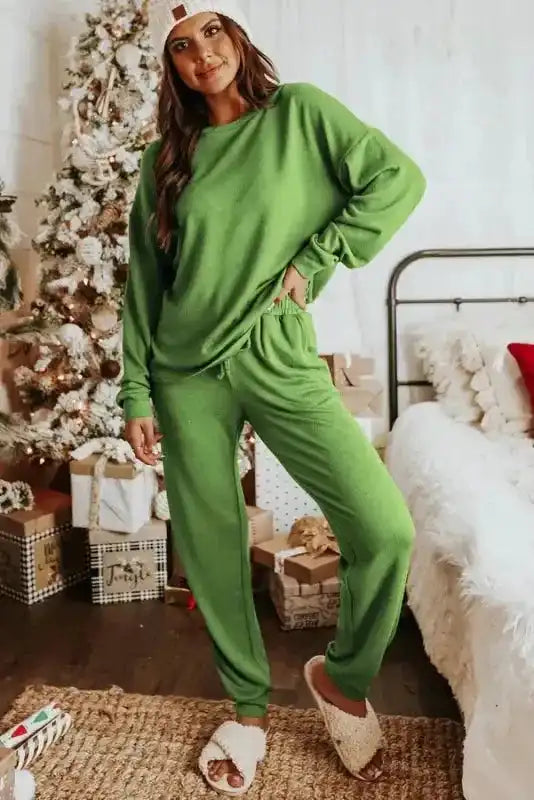Cozy Spinach Green Jogger Lounge Set styled with fuzzy slippers, perfect for holiday relaxation and casual indoor wear.