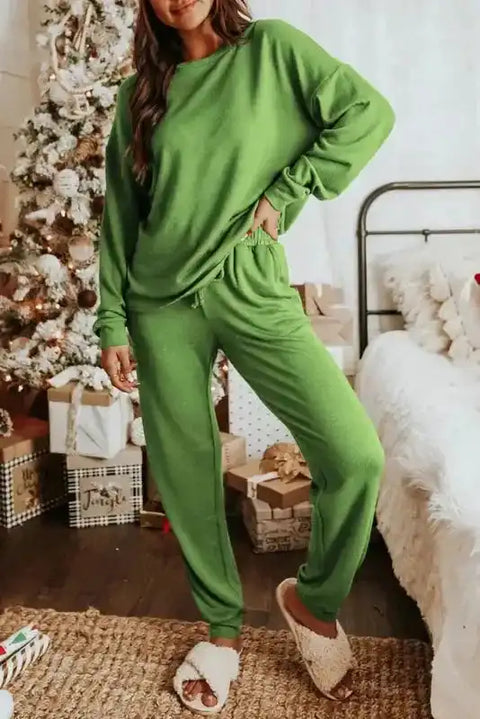 Spinach Green Jogger Pants Lounge Set with long sleeves and elastic waist, styled for cozy winter homewear near a Christmas tree.