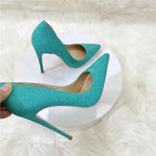 Side view of turquoise snake skin stilettos by FashionFitz, featuring pointed toes and slip-on design for stylish women's pumps.
