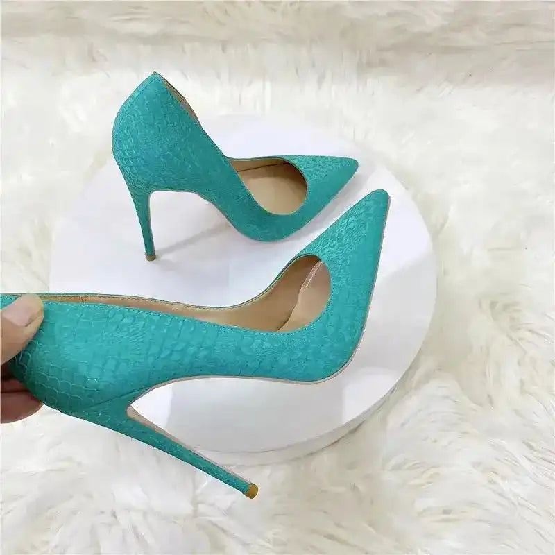 Side view of turquoise snake skin stilettos by FashionFitz, featuring pointed toes and slip-on design for stylish women's pumps.