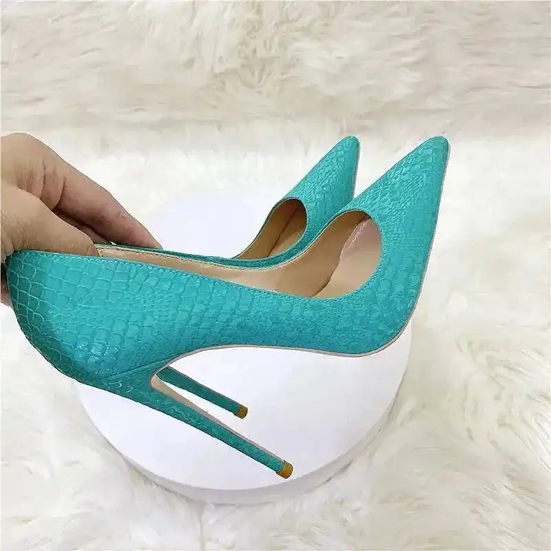 Close-up of turquoise FashionFitz Stiletto Heels with snake skin texture and pointed toes, perfect for stylish adult women's pumps.