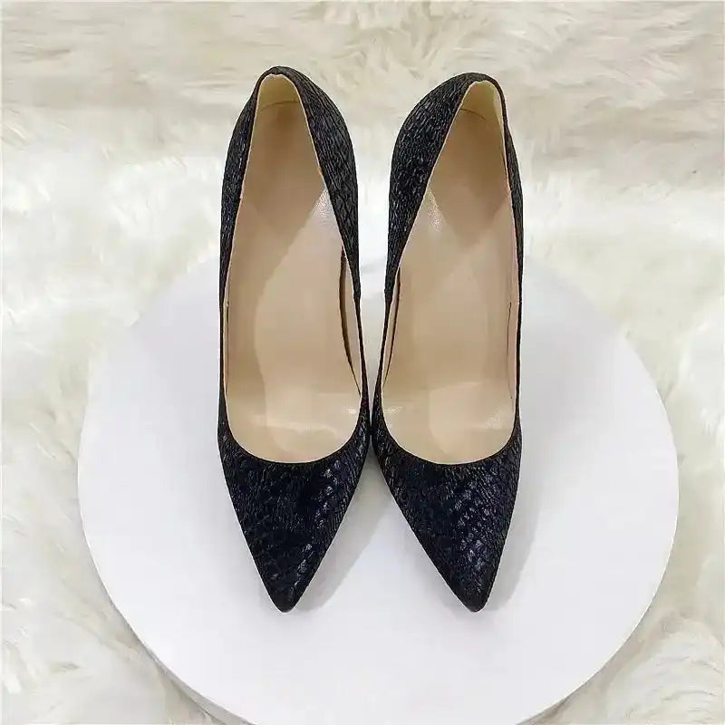 Top view of black PU pointed toe stilettos with snake skin pattern by FashionFitz, designed for adult women in the pumps category.