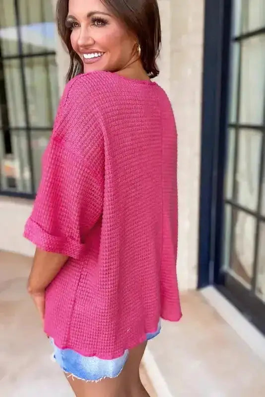 Back view of Strawberry Pink Knit Split‑Neck Top showing loose fit and cuffed sleeves, perfect for daily casual outfits in warm weather.