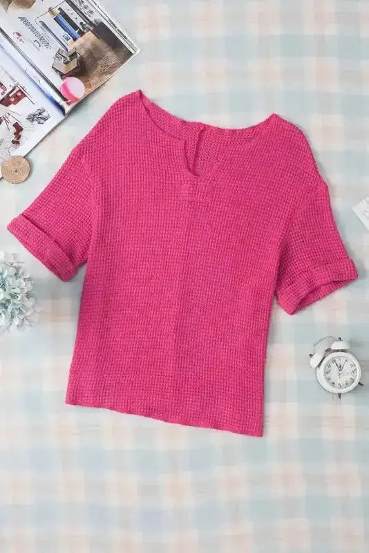Flat lay of Strawberry Pink Knit Split‑Neck Top with short sleeves and split neckline, ideal for casual summer wardrobes and easy layering.