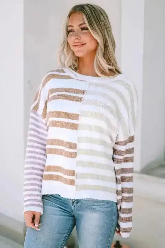 Front view of neutral tone drop shoulder sweater with color block stripe pattern and cozy oversized silhouette.