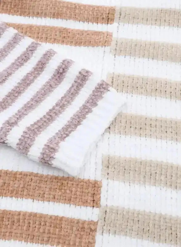 Detailed view of sleeve and body of neutral tone drop shoulder sweater with color block stripe design in soft knit.