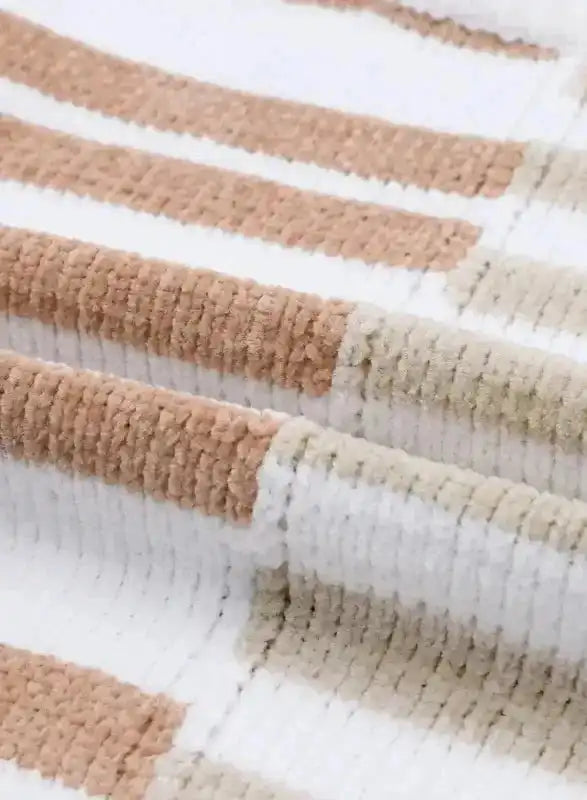 Detailed fabric view of neutral tone drop shoulder sweater showing soft knit texture and multicolor stripe pattern.