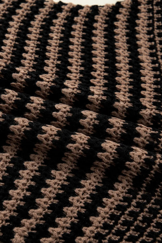 Textured close-up of black and taupe striped knit fabric on slouchy jumper. Lightweight and airy material perfect for everyday wear.