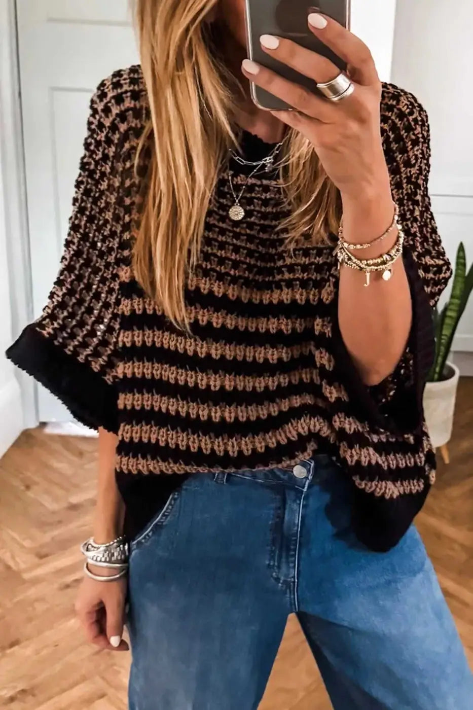 Striped Soft‑Knit Slouchy Jumper for Women in black and taupe, styled with blue jeans. Lightweight short sleeve sweater with relaxed fit.