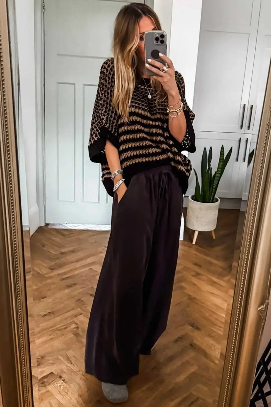 Relaxed fit striped soft-knit slouchy jumper in black and taupe, paired with wide-leg pants. Ideal lightweight sweater for summer layering.
