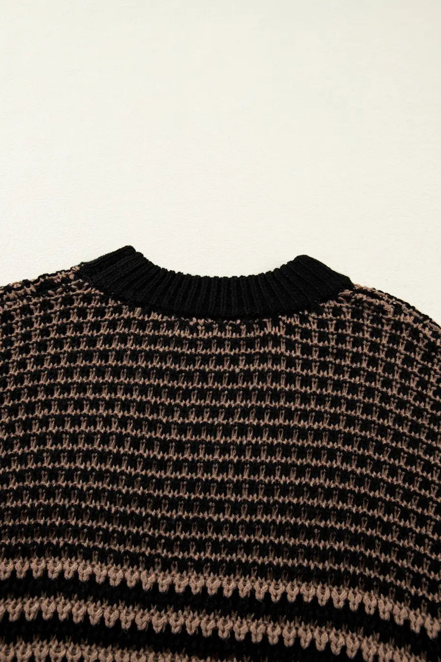 Back neckline detail of black and taupe striped soft-knit slouchy jumper. Features ribbed collar and breathable knit for summer comfort.