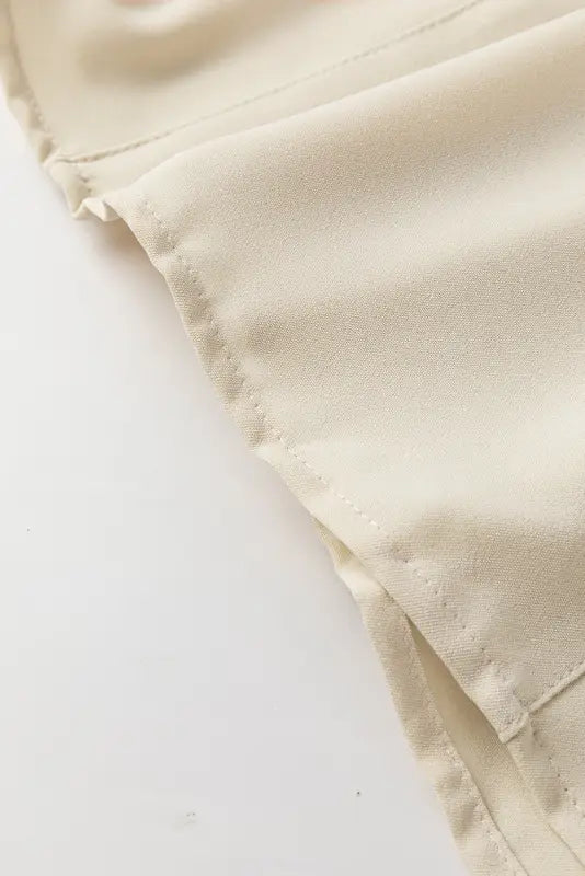 Close-up of folded corner on a stylish notched v-neck blouse with visible stitching