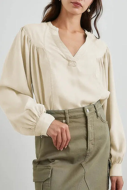 Stylish notched v-neck blouse with puffy sleeves paired with olive green cargo pants