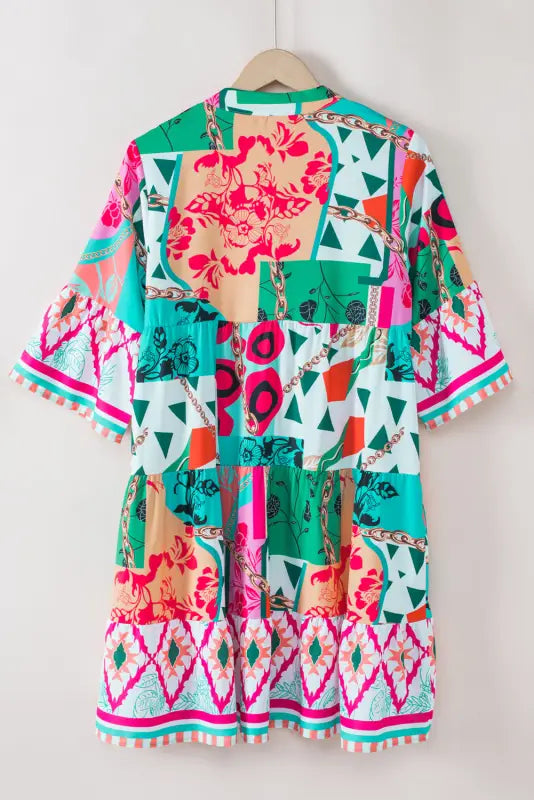 Colorful patterned mini dress with pom-pom trim on hanger - summer chic mini dress