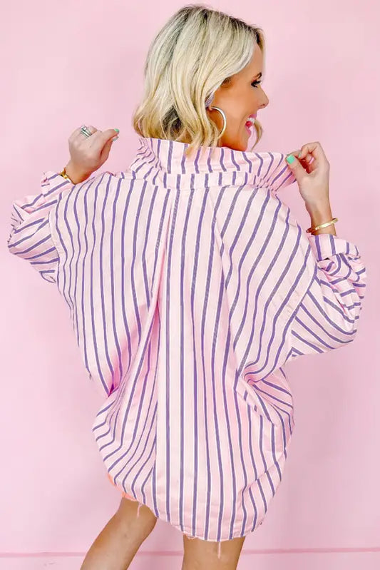 Blonde woman in sunset stripe lounge shirt, relaxing in striped pink and purple button-up