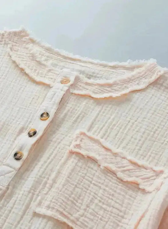 Detail shot of Crinkle Frayed Tunic Top neckline and pocket, showcasing soft crinkle fabric and raw edge design.