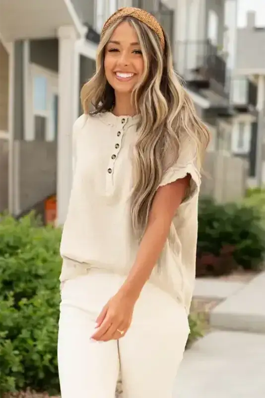 Model wearing Crinkle Frayed Tunic Top with buttoned neckline and soft crinkle texture, perfect for warm weather layering.