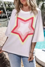 Front view of white oversized T-shirt featuring colorful layered star patch. Half sleeve design perfect for relaxed UK fashion styling.