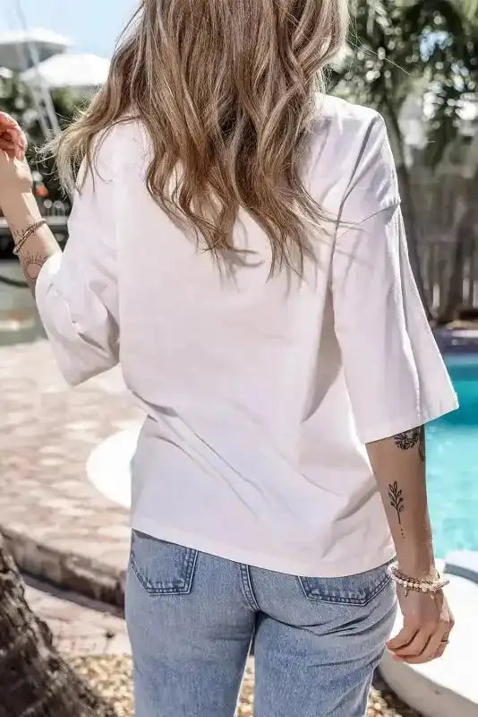 Back view of white oversized half sleeve T-shirt showing loose fit and soft fabric. Ideal for casual daily wear in UK fashion trends.