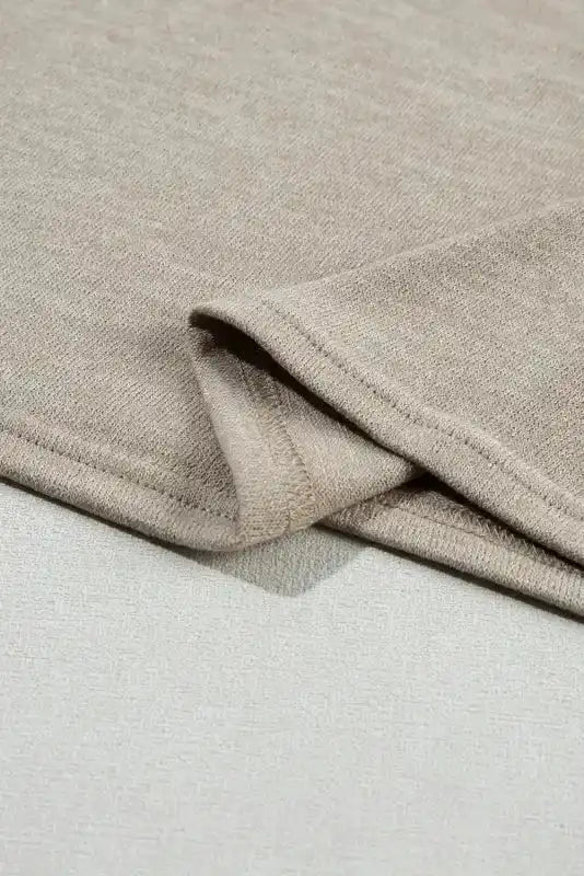 Hem detail of Smoke Gray Batwing Tee, highlighting its neat finish and soft fabric for everyday wear.