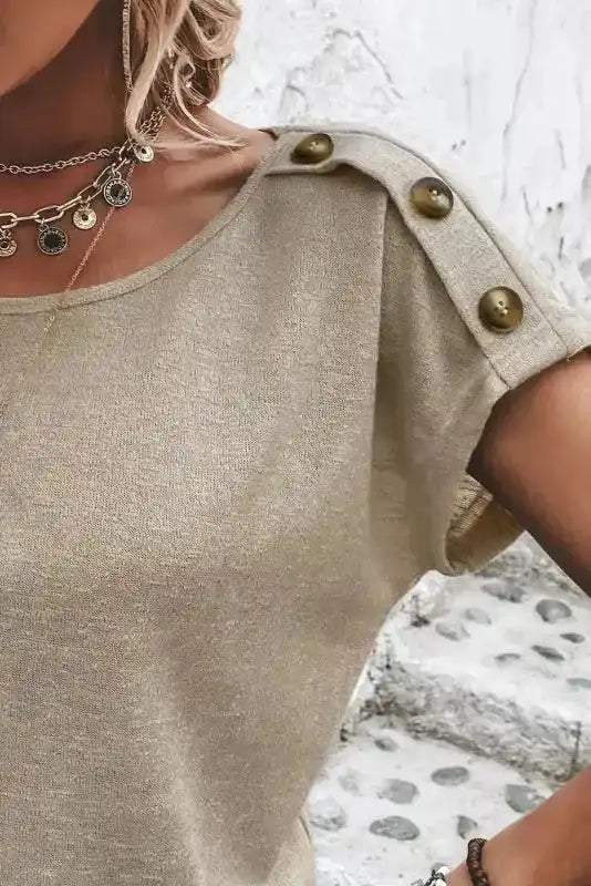 Close-up of shoulder button detail on Smoke Gray Batwing Tee, emphasizing its stylish design element.