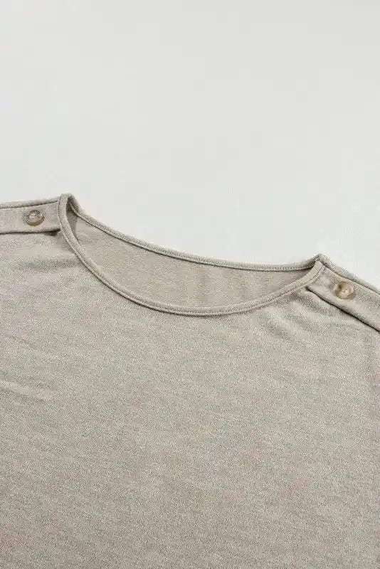 Neckline and shoulder button close-up of Smoke Gray Batwing Tee, showing quality stitching and design.