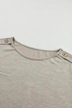 Neckline and shoulder button close-up of Smoke Gray Batwing Tee, showing quality stitching and design.