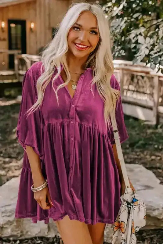 Model wearing Velvet Babydoll Tunic Shirt in solid pink, highlighting its flowy silhouette and button-down front for versatile styling.