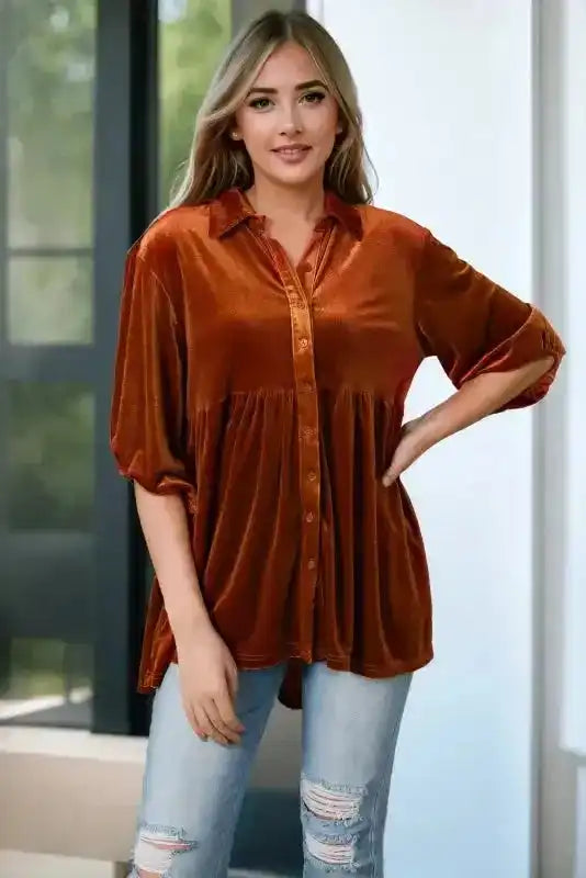 Rust velvet babydoll tunic with button front and A-line silhouette, styled casually with jeans for a daily fall look.