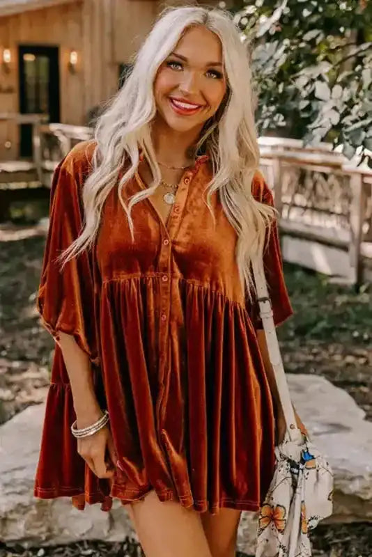 Rust velvet babydoll shirt with button-down front and relaxed fit, styled with shorts and accessories for a cozy fall vibe.