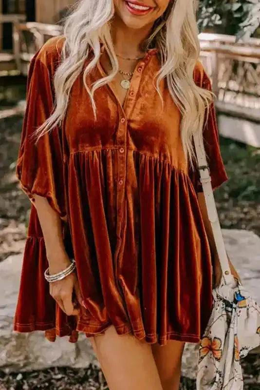 Shop Velvet Tunic Babydoll Shirt in rust orange with a flowy silhouette and button front, styled with shorts and accessories outdoors.