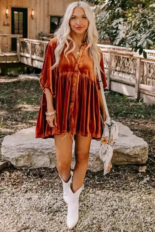 Full outfit featuring rust Velvet Babydoll Tunic with white boots and a printed tote, styled for a chic autumn day.