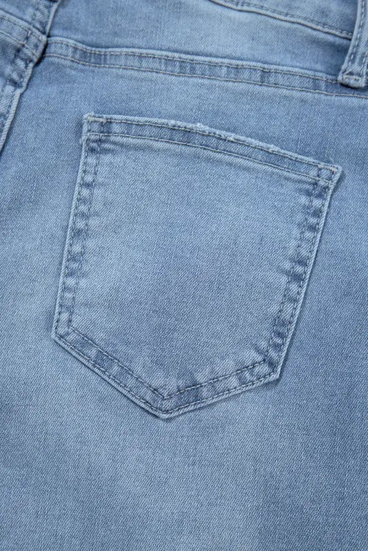 Back pocket of light blue urban edge asymmetrix jeans for a relaxed, stylish look