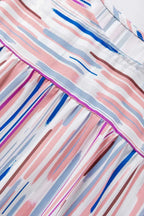 Detailed view of the blouse's upper back showing the vibrant rainbow stripe splash print and fine stitching.