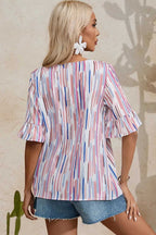Back view of the Rainbow Stripe Splash Blouse highlighting the multicolor vertical brushstroke pattern and flowy silhouette.