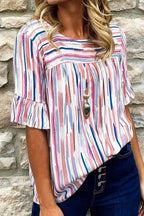 Vibrant Rainbow Stripe Splash Blouse with half sleeves and ruffle cuffs, styled casually with dark denim jeans for a chic summer look.