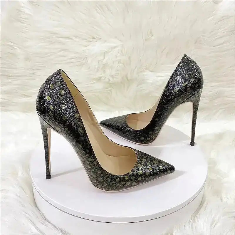 Stylish snake-effect stiletto heels displayed on a white platform, combining retro charm with modern elegance for special occasions.
