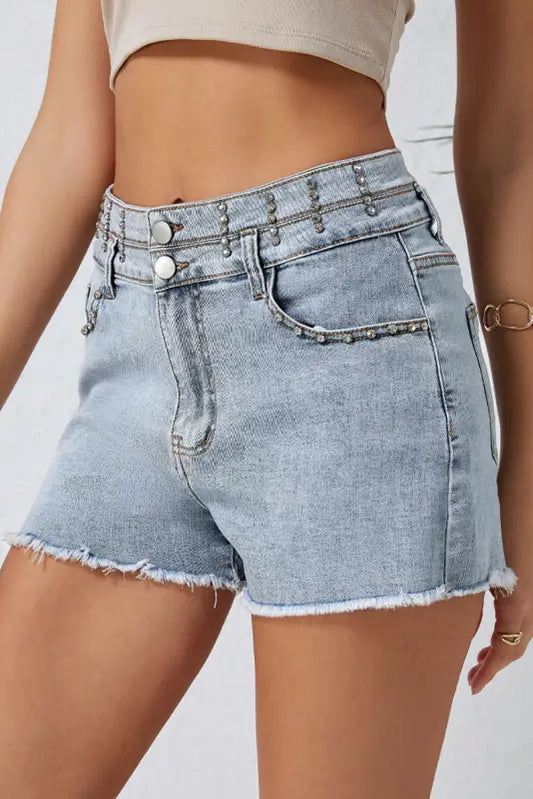 Vintage wash denim shorts: light blue, frayed edges, metal studs on waistband, relaxed fit