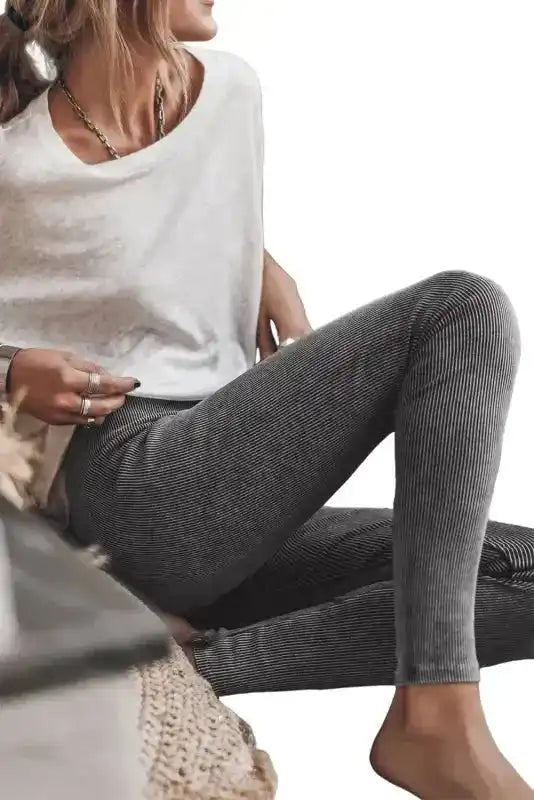 Dark grey ribbed leggings with vintage wash shown in a relaxed pose, emphasizing comfort and casual style for everyday wear.