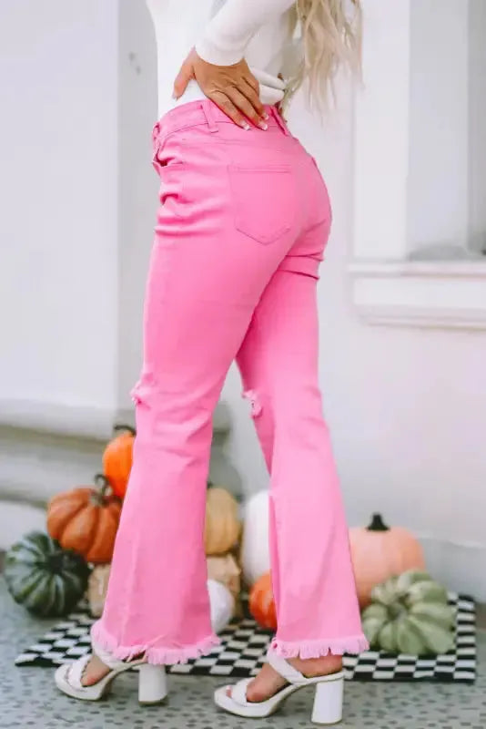Close-up of raw hem and ripped distressed detail on pink flare leg denim jeans Fashionfitz UK