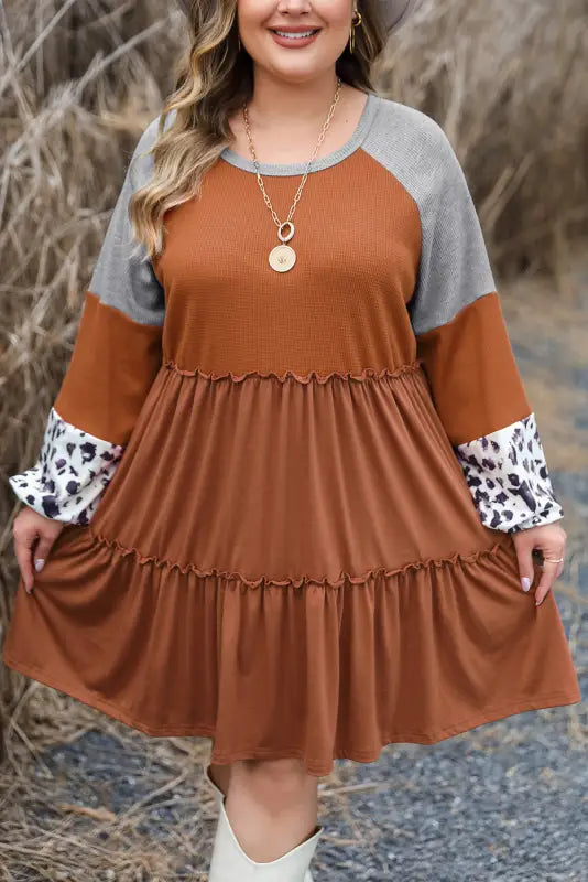 Rust-colored waffle ruffle mini dress with gray and leopard print sleeves