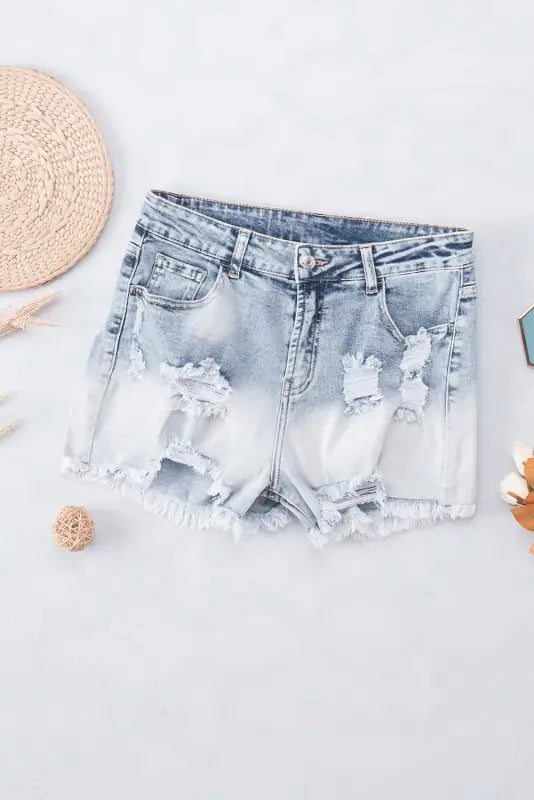 Washed distressed denim shorts with ripped details and a relaxed faded ombre effect