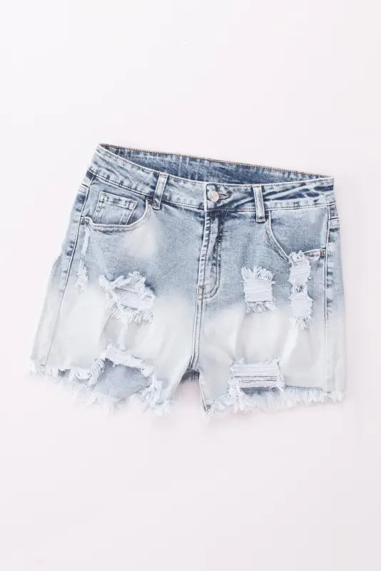 Washed distressed denim shorts with ripped, frayed edges for a casual, relaxed style