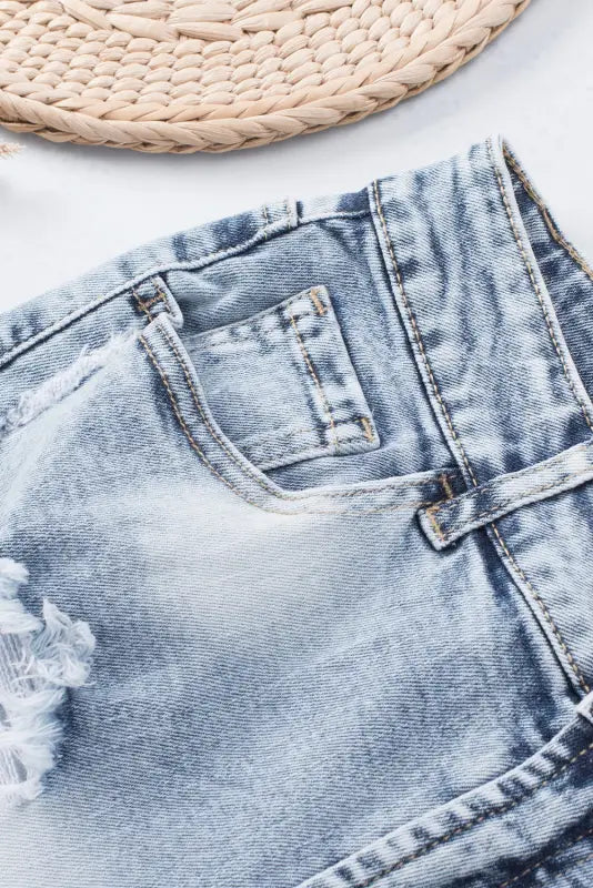 Washed distressed denim shorts with frayed edges and visible pockets for a relaxed look