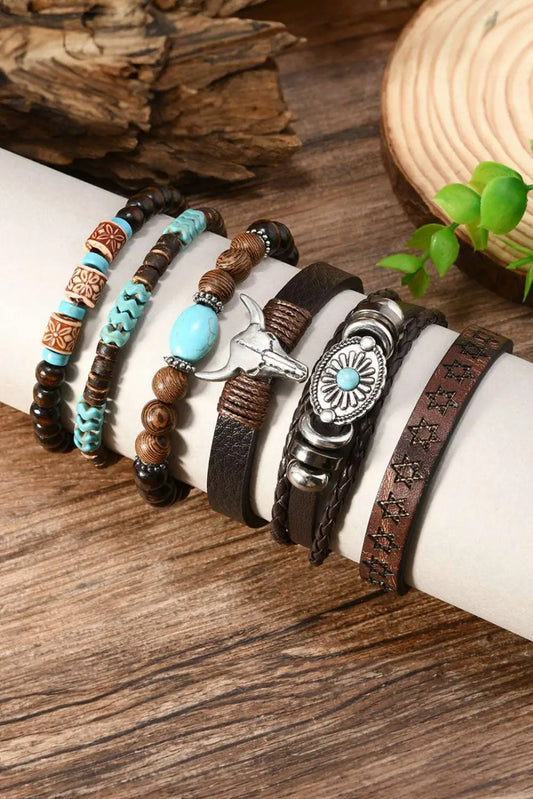 Set of Western Bull Skull Turquoise Bracelets on a wrist with wooden background